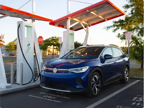 Volkswagon EV parked next to Electrify Canada charging stations